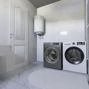 Contemporary laundry room featuring a washer, dryer, and water heater on tiled flooring.